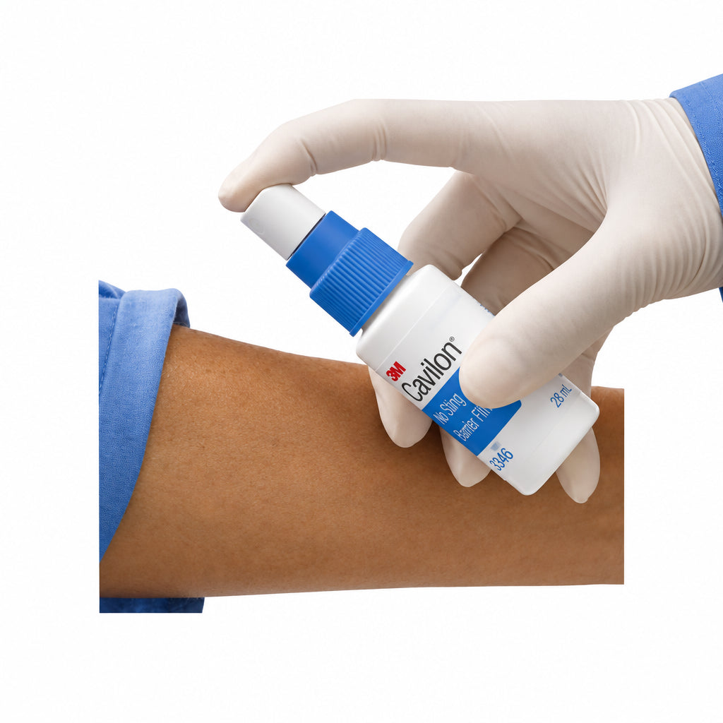 Hand applying a tube of 3M Cavilon to a person's arm on a white background - okotoks hc pharmacy