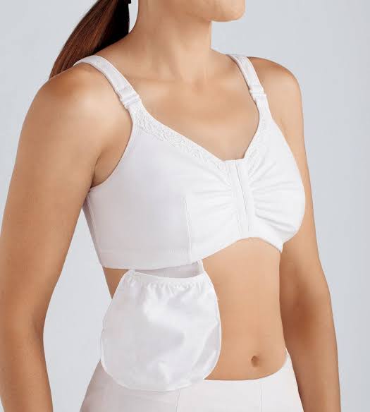 A white bra with a front pouch, shown on a model against a light gray background. - okotoks hc pharmacy