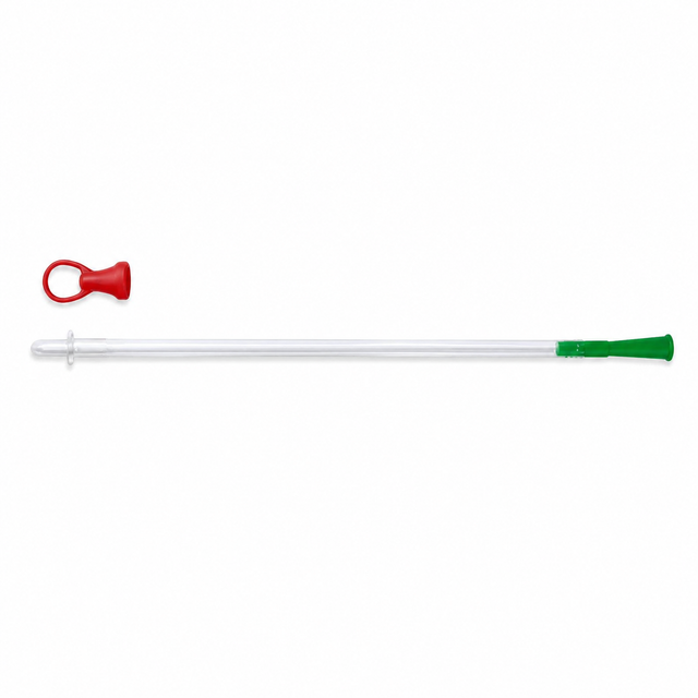 A long clear catheter with a green cap, shown horizontally on a white background, with a small red ring-shaped accessory above it. - okotoks hc pharmacy