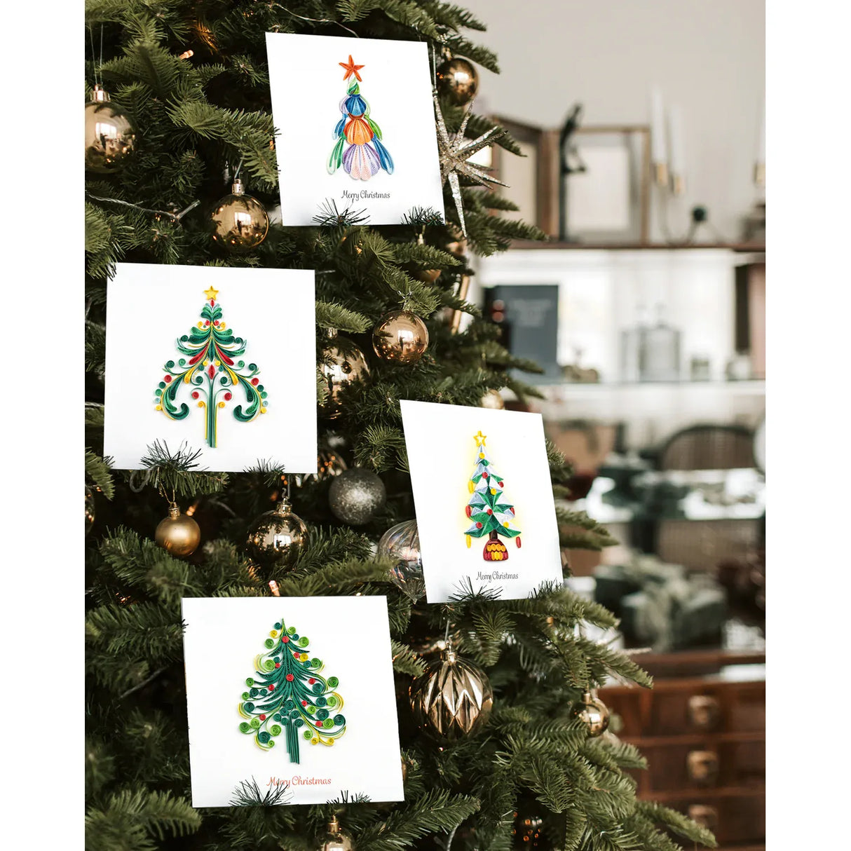 Decorative Christmas cards with tree designs attached to a Christmas tree. - okotoks hc pharmacy