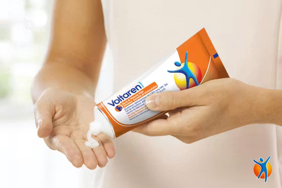 Person applying Voltaren cream to their hand with a focus on the product packaging. - okotoks hc pharmacy