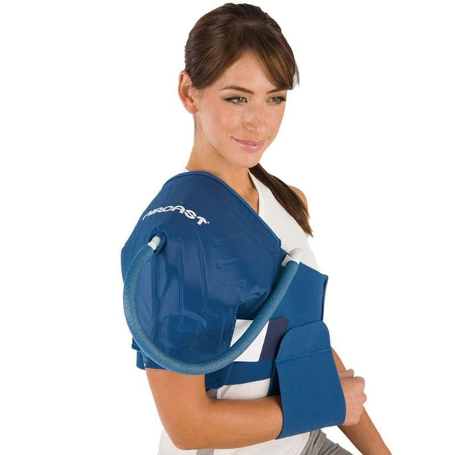Woman wearing a blue shoulder brace with a visible brand logo on a white background - okotoks hc pharmacy