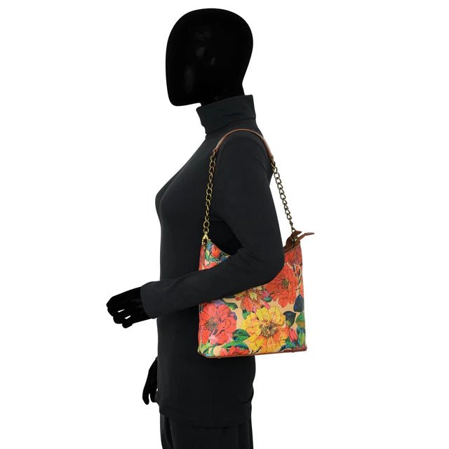 Mannequin wearing a black outfit with a colorful floral handbag on a white background - okotoks hc pharmacy