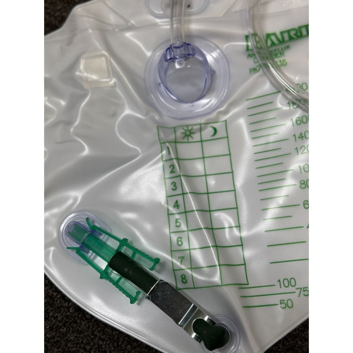 Medical device with a clear plastic bag and green measurement markings on a dark background - okotoks hc pharmacy