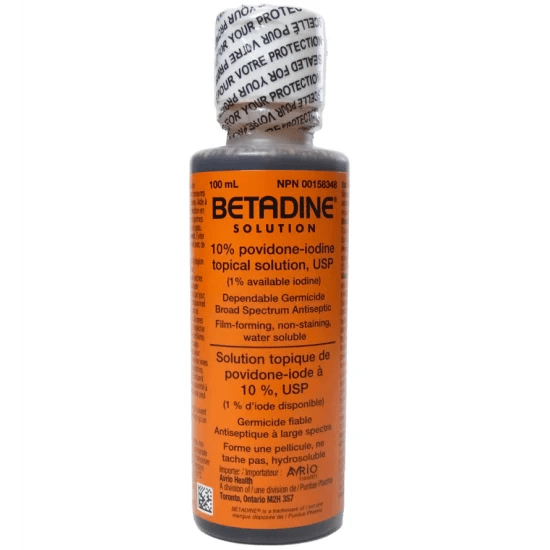 Bottle of Betadine solution with orange label on a white background - Okotoks HC Pharmacy