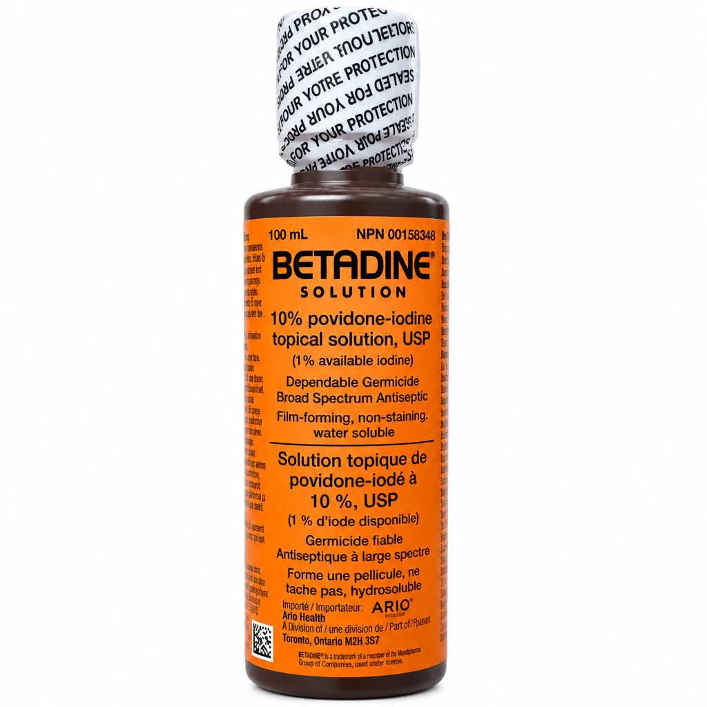 Bottle of Betadine solution with orange label on a white background - Okotoks HC Pharmacy