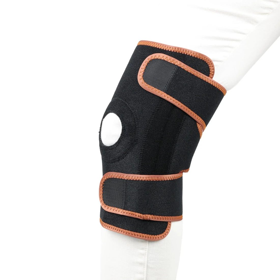 Black knee brace with brown accents on a white background - okotoks hc pharmacy
