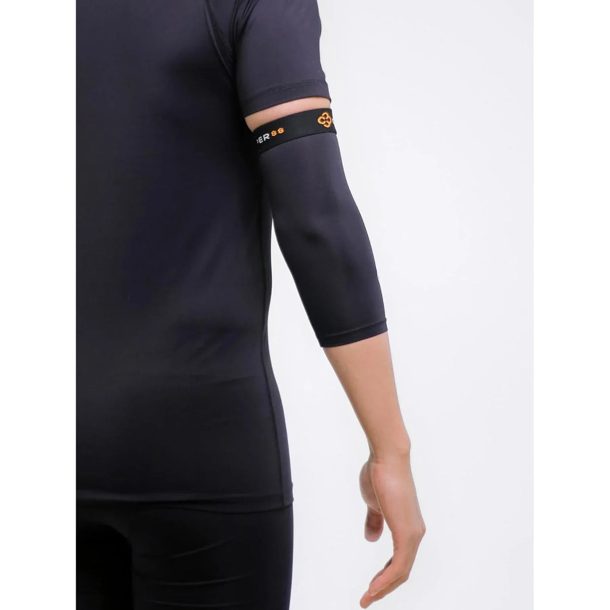 Person wearing a black sleeveless top and black leggings with a white background - Okotoks HC Pharmacy