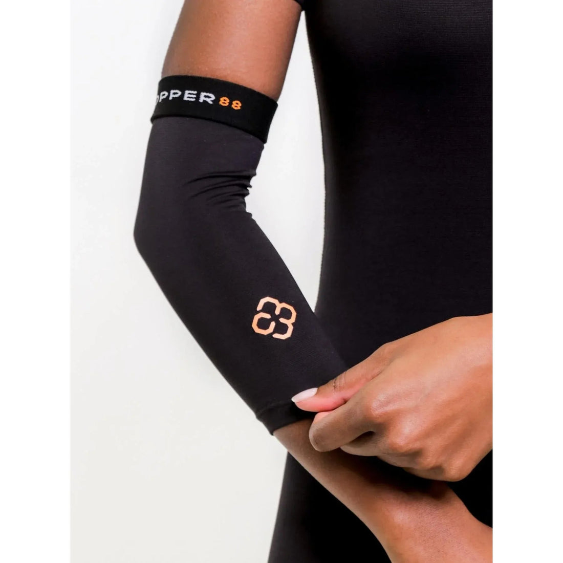 Person wearing a black arm sleeve with a brand logo on a white background - Okotoks HC Pharmacy