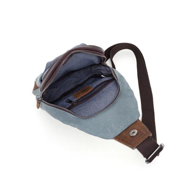 Blue sling bag with brown strap on a white background - okotoks hc pharmacy