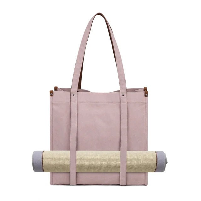 Pink tote bag with a rolled-up yoga mat on a white background - okotoks hc pharmacy