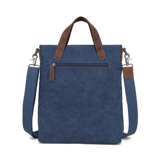 Blue tote bag with brown straps on a white background - okotoks hc pharmacy