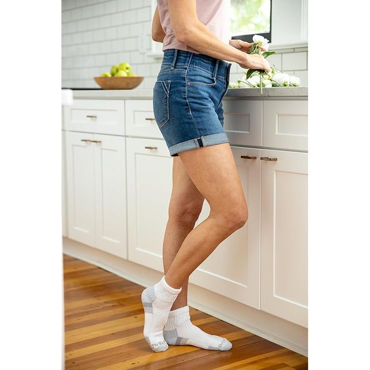 Person wearing blue denim shorts in a kitchen setting - okotoks hc pharmacy