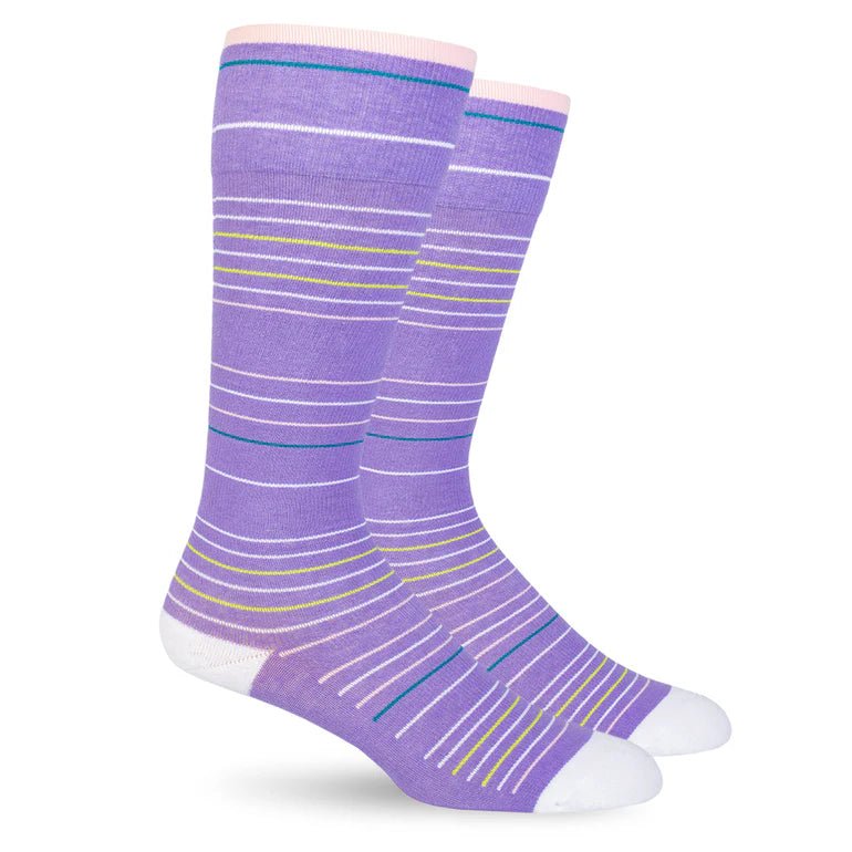 A pair of crew socks in lavender purple with white, light blue, and yellow horizontal stripes, featuring white toes and heels, shown against a plain white background. - okotoks hc pharmacy