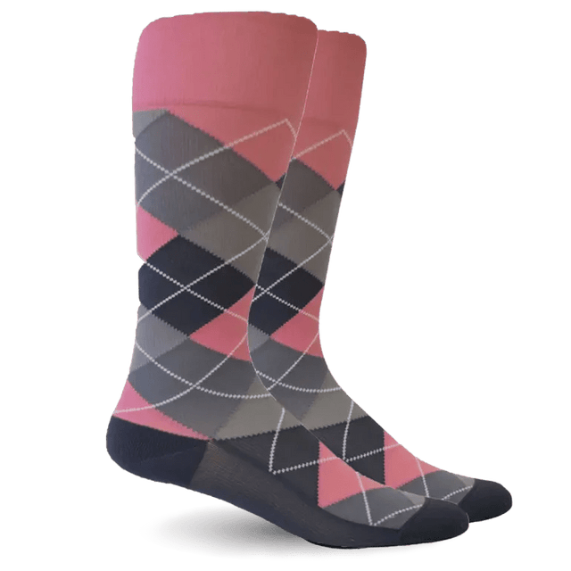 A pair of argyle socks with a color gradient transitioning from pink at the top to dark gray and navy at the bottom, featuring a white dotted diamond pattern. - okotoks hc pharmacy