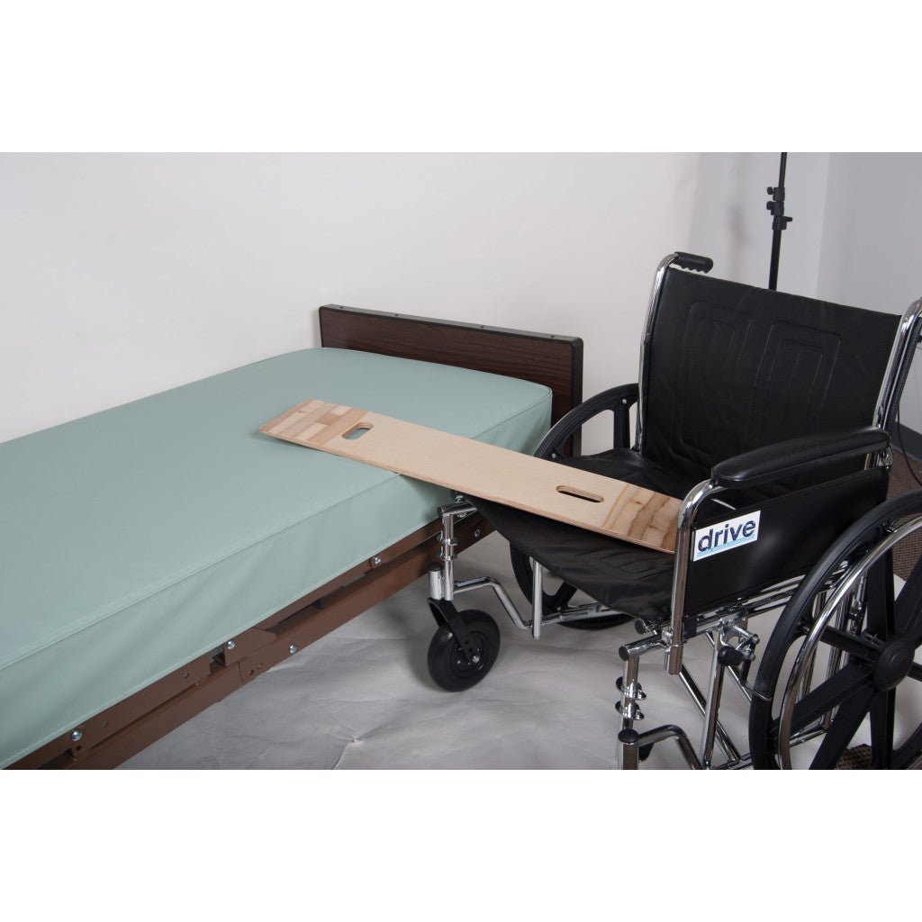 Wheelchair with a wooden board attached to a bed in a room. - okotoks hc pharmacy