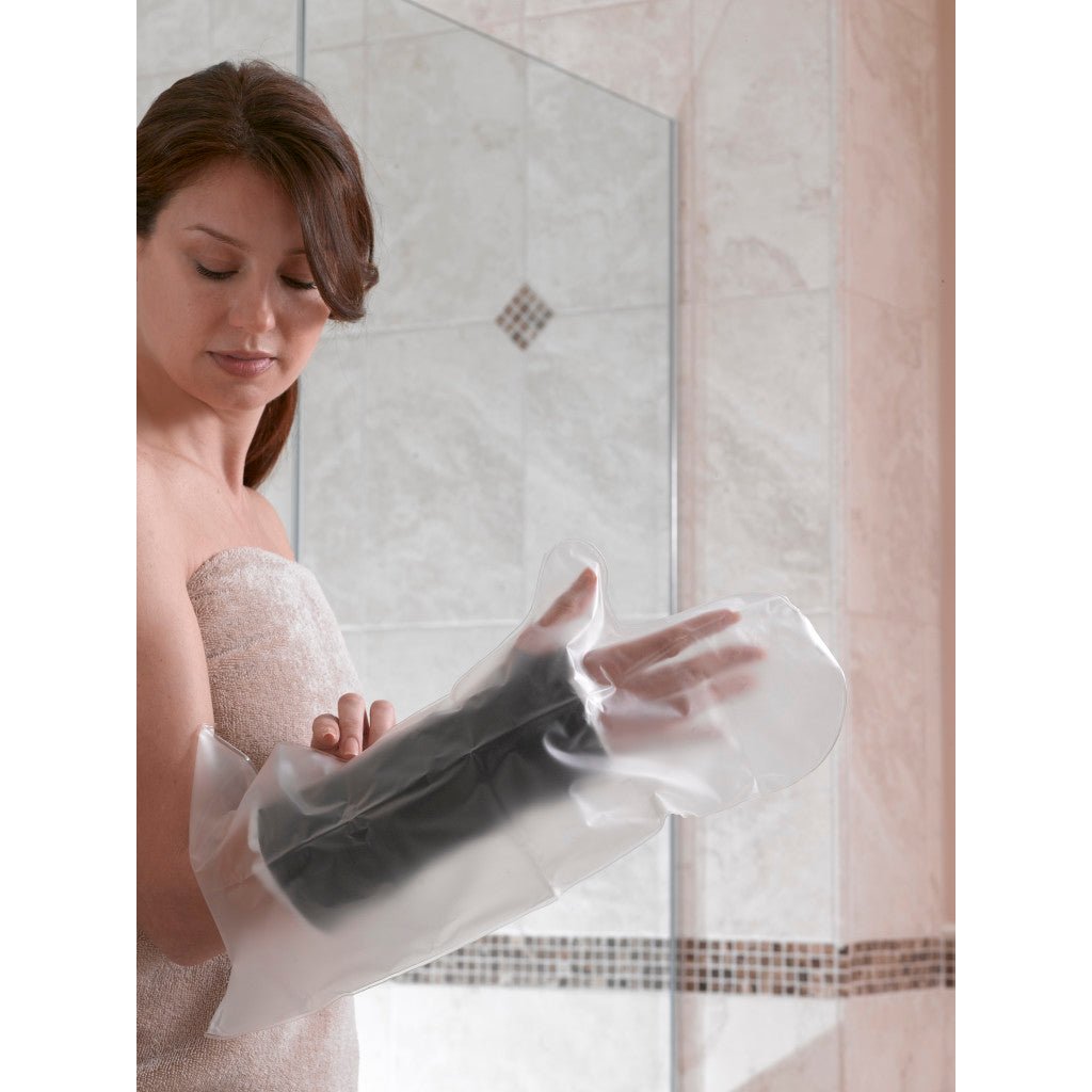 Woman applying a black foot mask in front of a mirror. - okotoks hc pharmacy
