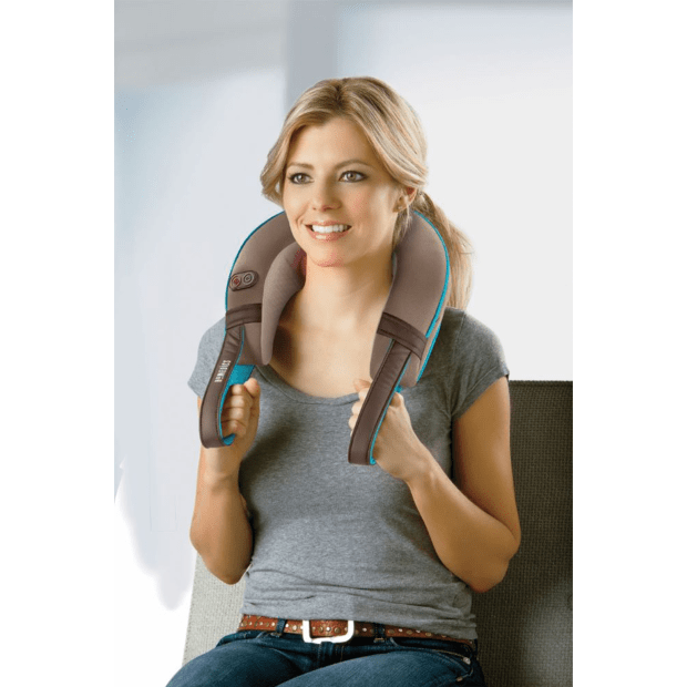 Woman using a neck massager with a plain background - okotoks hc pharmacy