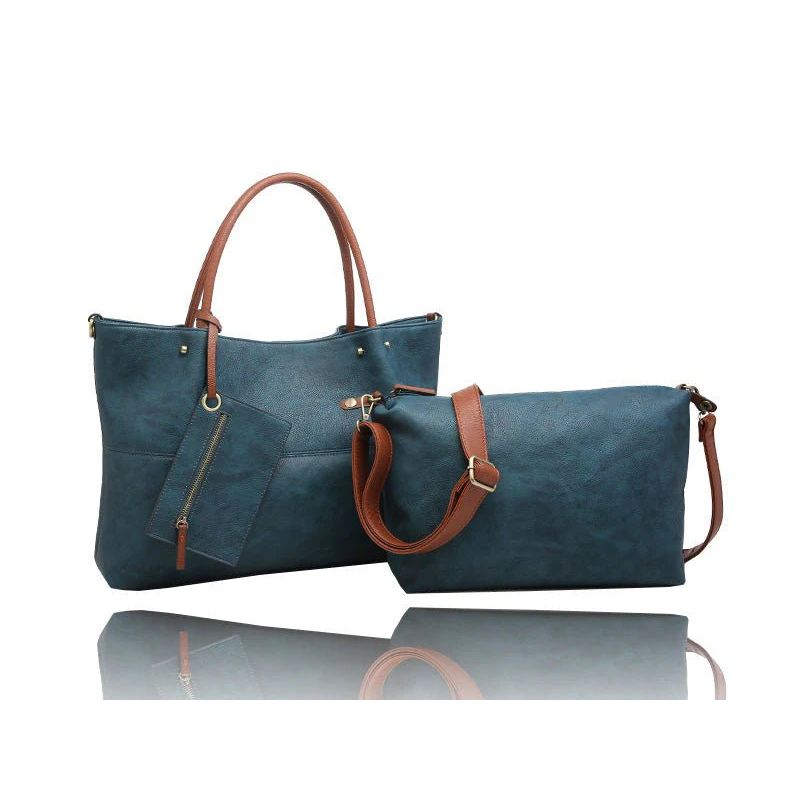 A matching two-piece handbag set consisting of a large tote bag and a smaller zippered pouch, both in a textured teal blue material with brown faux-leather handles and straps, displayed on a reflective white surface. - okotoks hc pharmacy