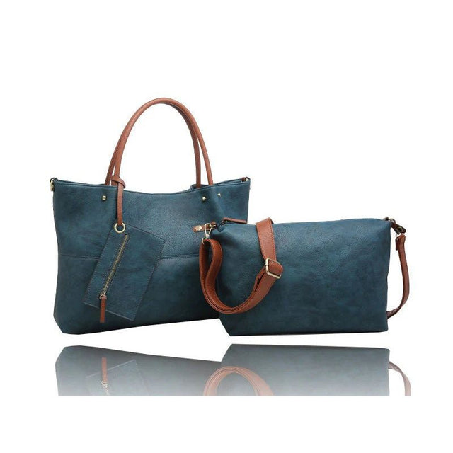 A matching two-piece handbag set consisting of a large tote bag and a smaller zippered pouch, both in a textured teal blue material with brown faux-leather handles and straps, displayed on a reflective white surface. - okotoks hc pharmacy