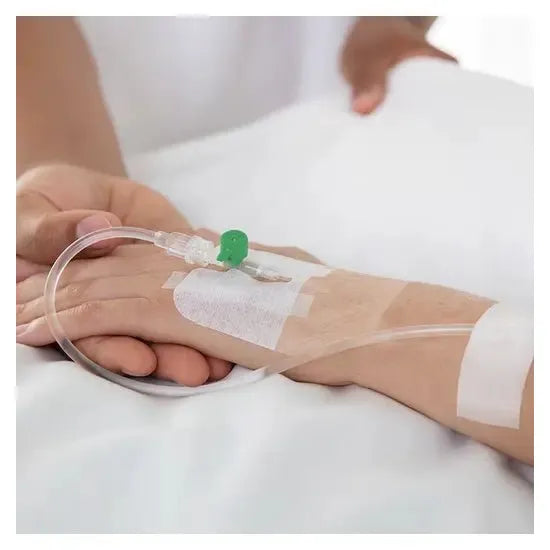 Close-up of a hand with an IV drip on a white background - okotoks hc pharmacy