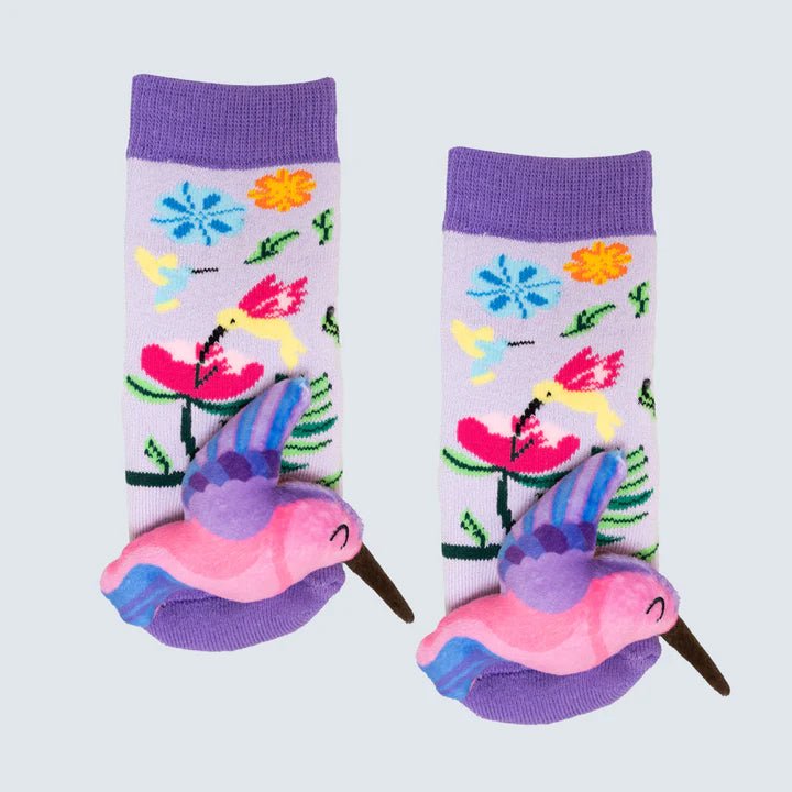 Pair of socks with colorful hummingbird design on a light gray background - okotoks hc pharmacy