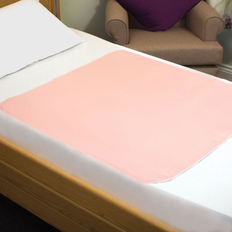 Pink mattress topper on a bed with a blurred background - okotoks hc pharmacy