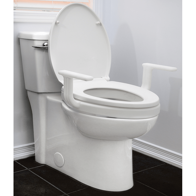 White toilet with a raised seat and armrests in a bathroom setting. - okotoks hc pharmacy