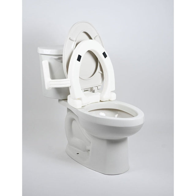 White toilet with an open seat on a light gray background - okotoks hc pharmacy