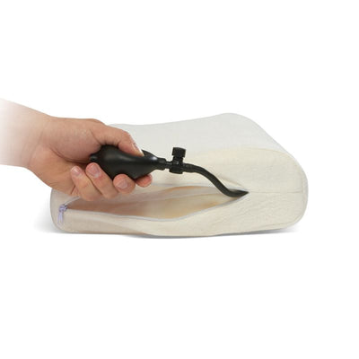 Hand using a pump to inflate a white air-filled cushion on a white background - Okotoks HC Pharmacy