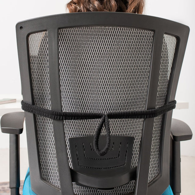 Person sitting on a black office chair with mesh backrest - okotoks hc pharmacy