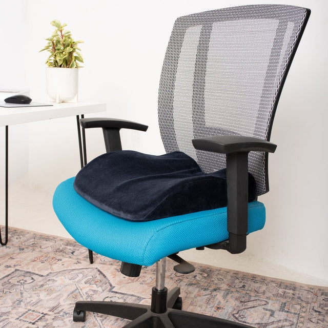Blue office chair with a black cushion in a room setting. - okotoks hc pharmacy