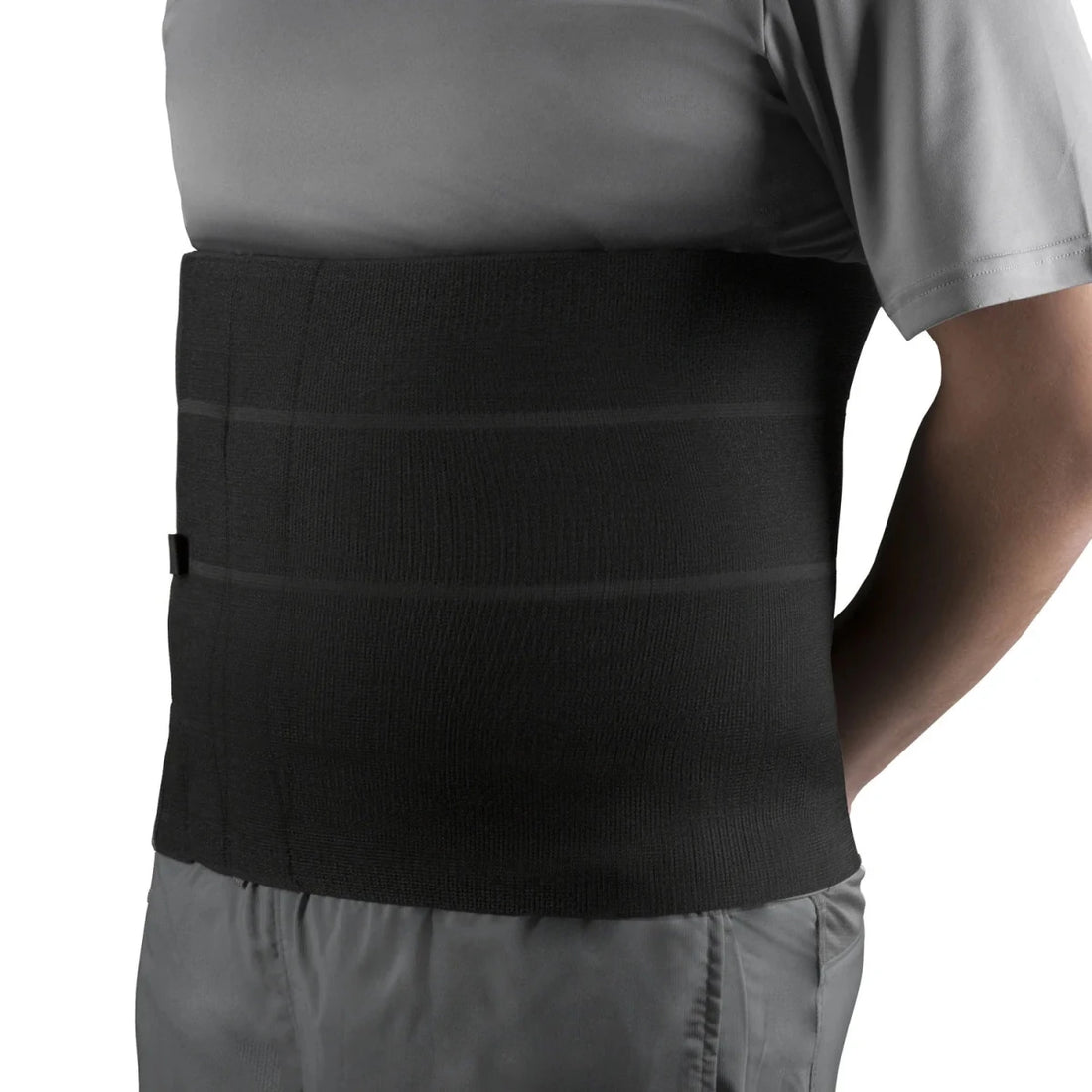 Person wearing a black compression wrap on their waist against a white background - okotoks hc pharmacy