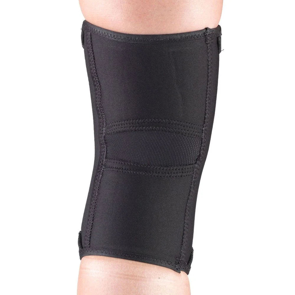 Black knee brace on a person's leg against a white background - okotoks hc pharmacy