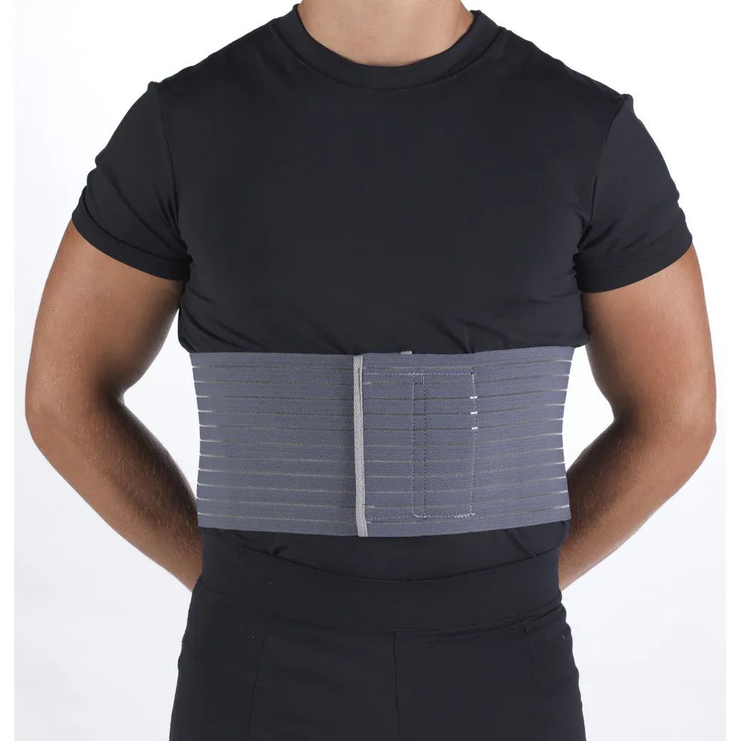 Person wearing a black shirt with a gray compression wrap on the torso against a white background - okotoks hc pharmacy
