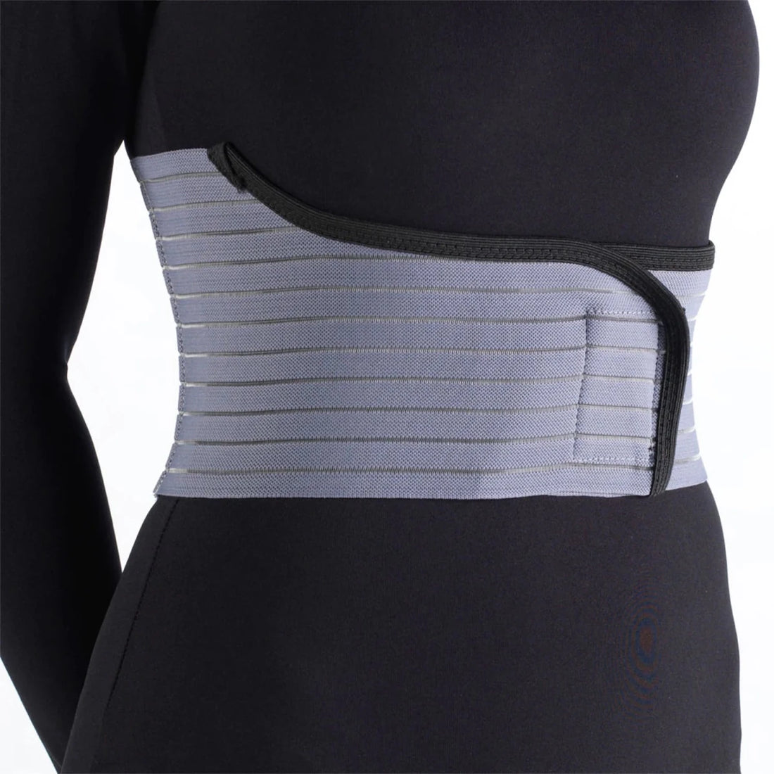 Gray back brace worn by a person on a white background - okotoks hc pharmacy