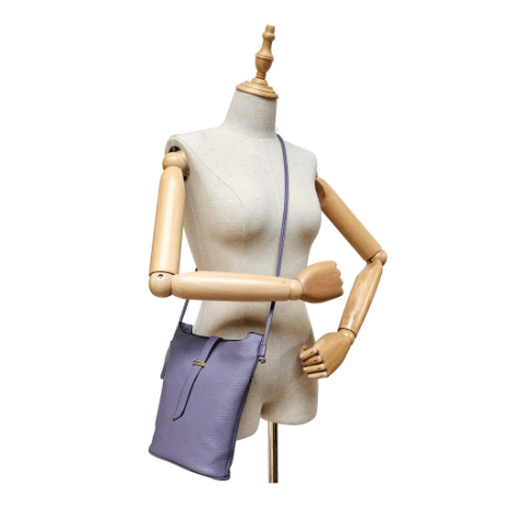 Mannequin wearing a purple handbag on a white background - okotoks hc pharmacy