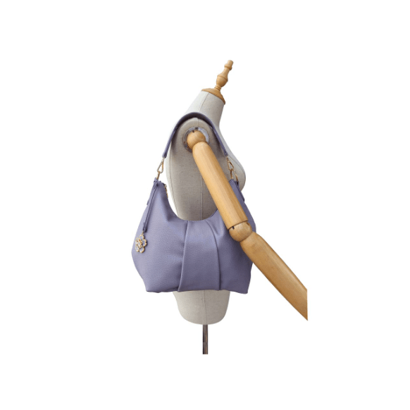 Purple handbag on a mannequin with a white background - okotoks hc pharmacy