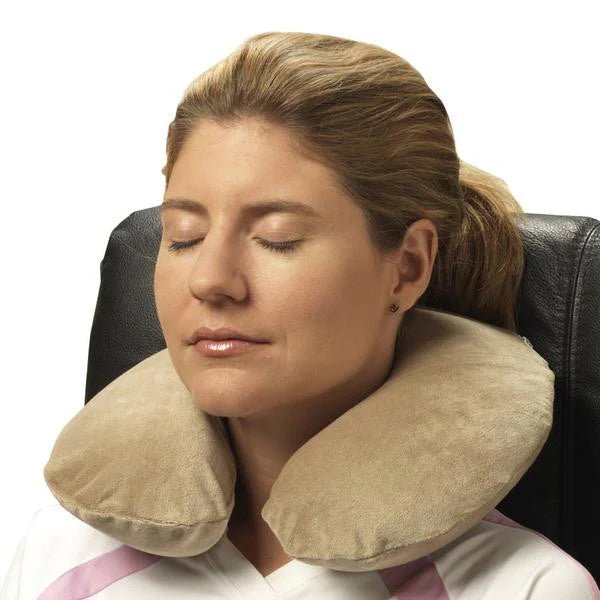 Woman using a beige travel neck pillow in a chair. - okotoks hc pharmacy