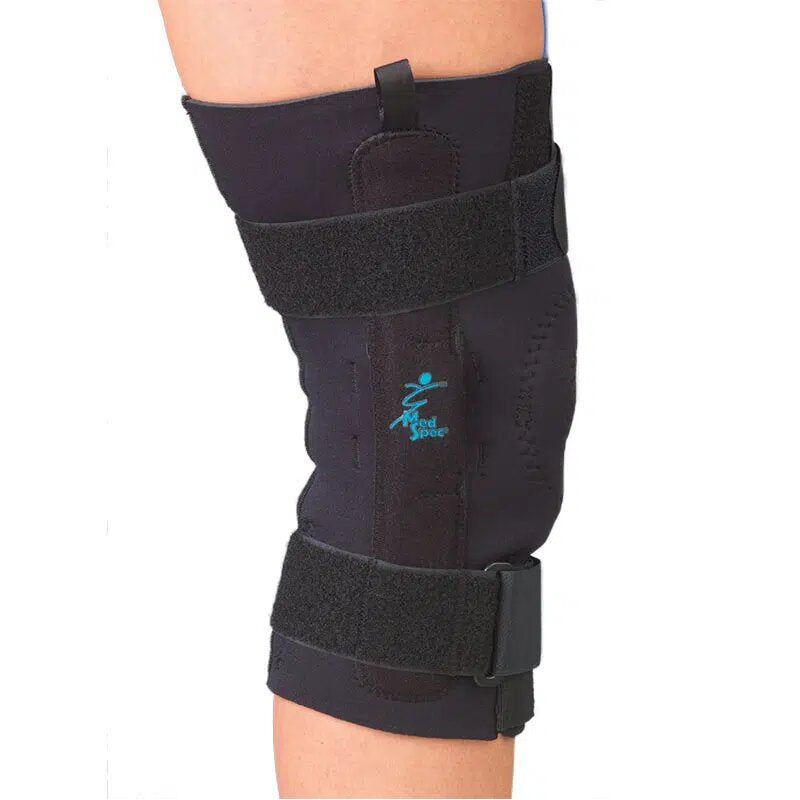 Black knee brace on a person's leg with a visible brand logo against a white background - Okotoks HC Pharmacy
