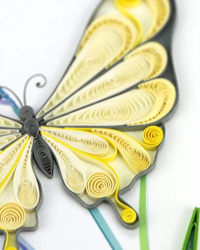 Quilled butterfly art with yellow and gray patterns on a white background - okotoks hc pharmacy