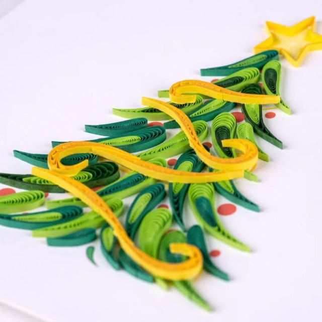 Quilled paper Christmas tree with a yellow star on a white background - okotoks hc pharmacy
