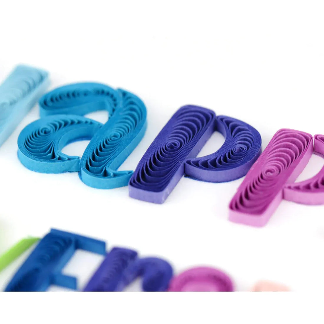 Colorful paper quilling letters on a white background - okotoks hc pharmacy