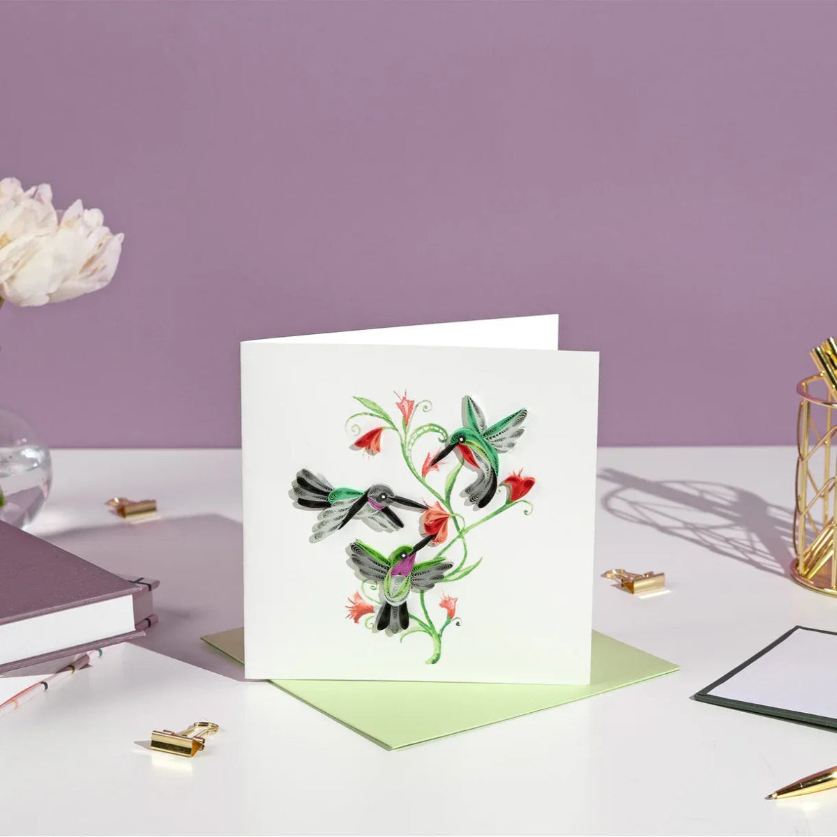 Greeting card with hummingbird design on a desk with stationery items - okotoks hc pharmacy