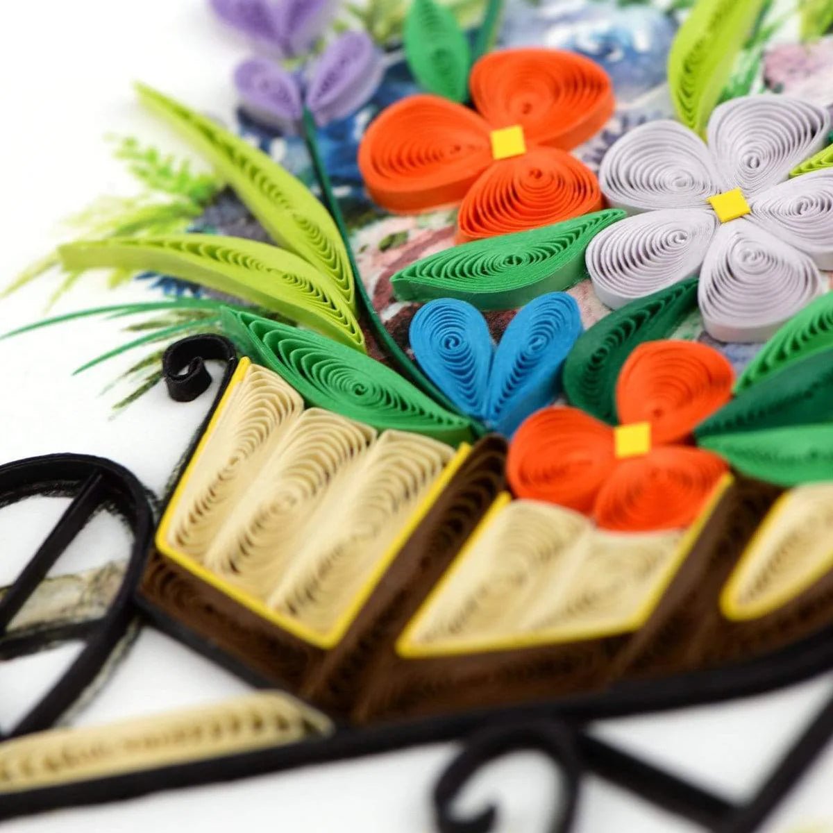 Quilled paper art with flowers and leaves on a white background - okotoks hc pharmacy