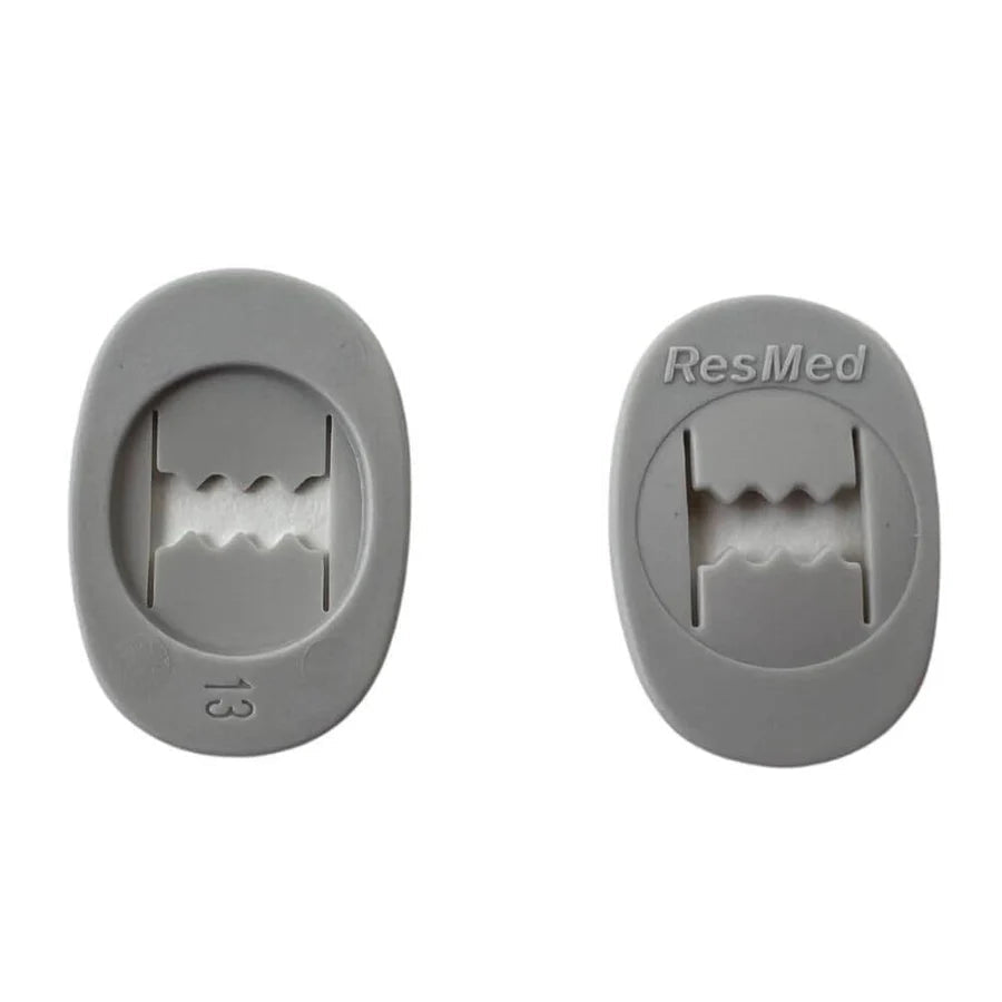 Two gray headgear clips with 'ResMed' branding on a white background. - okotoks hc pharmacy