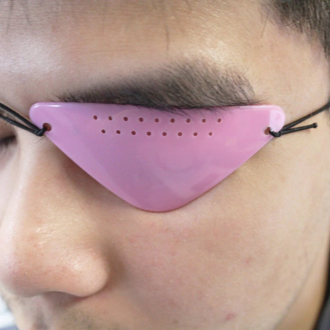 Person wearing a pink eye patch on one eye - okotoks hc pharmacy