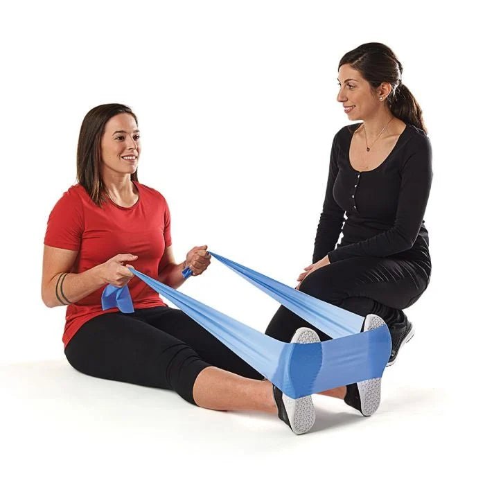Two women using a resistance band on a white background - okotoks hc pharmacy