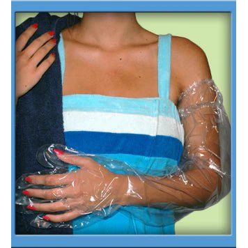 Person wearing a blue dress with clear plastic sleeves and gloves. - okotoks hc pharmacy