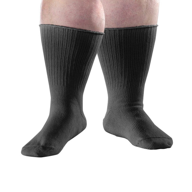 A pair of black ribbed crew socks worn on a person's legs, shown against a plain white background. - okotoks hc pharmacy